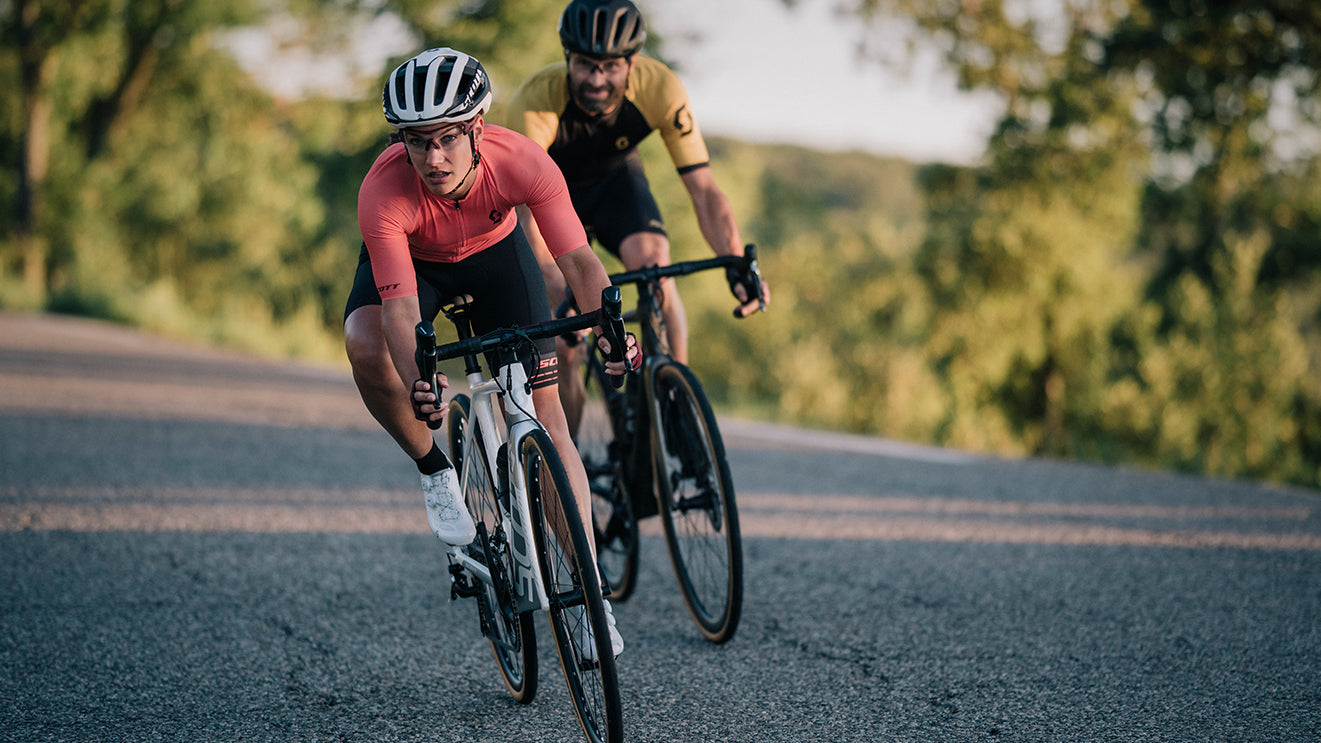 Two cyclists riding road bike