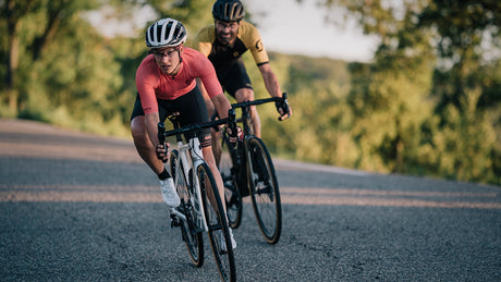 Two cyclists riding road bike