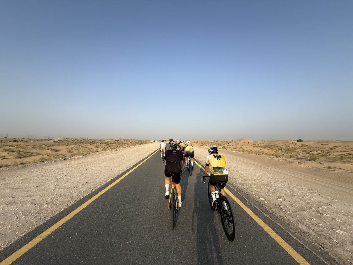 Two cyclists riding on Al Qudra's dedicated desert cycling track in Dubai
