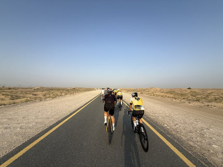 Two cyclists riding on Al Qudra's dedicated desert cycling track in Dubai