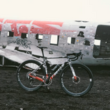 Bicycle in front of a crashed airplane fuselage